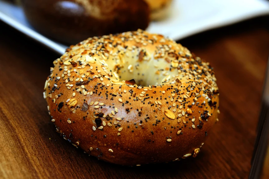 An everything bagel with sesame and poppy seeds